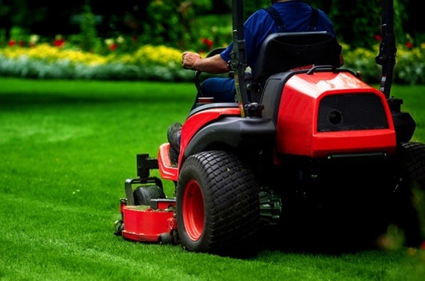 lawn care worker cutting grass